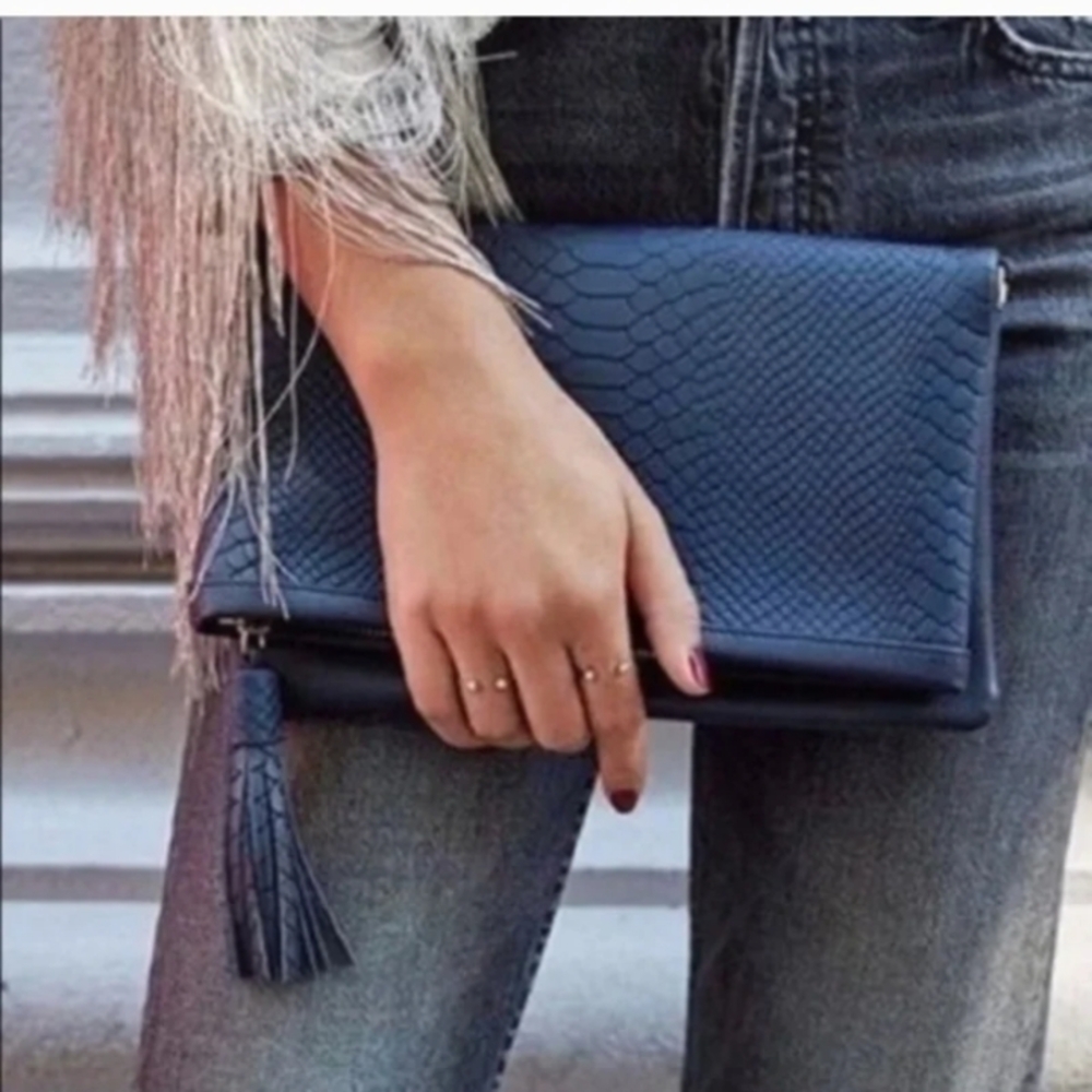 GiGi New York is owned by Graphic Image, a family-owned Navy Clutch Bag